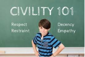 boy standing in front of blackboard with word civility on it