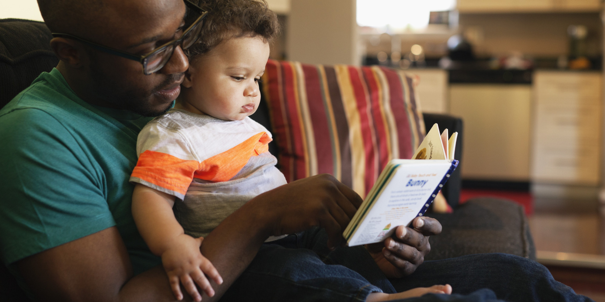 image of father reading to baby