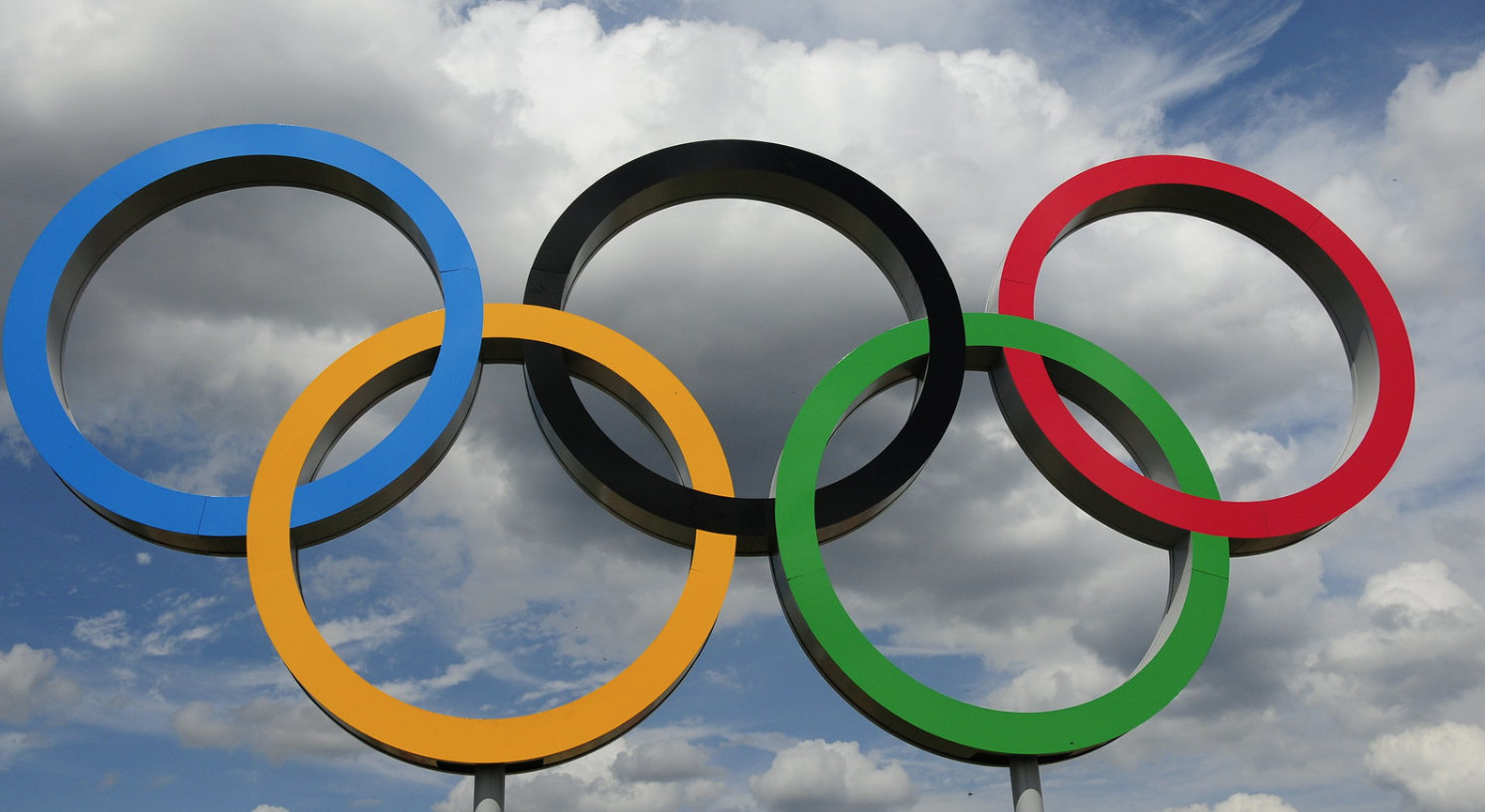 olympic rings against sky with some clouds